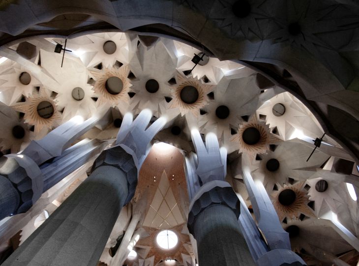 The interior of the Sagrada Família looks complicated, but if you study the geometry carefully, you'll see that it is composed using a series of mathematical rules. In this case, the ceiling comprises of hyperboloids. The triangular cutouts follow the ruled geometry of the hyperboloids.